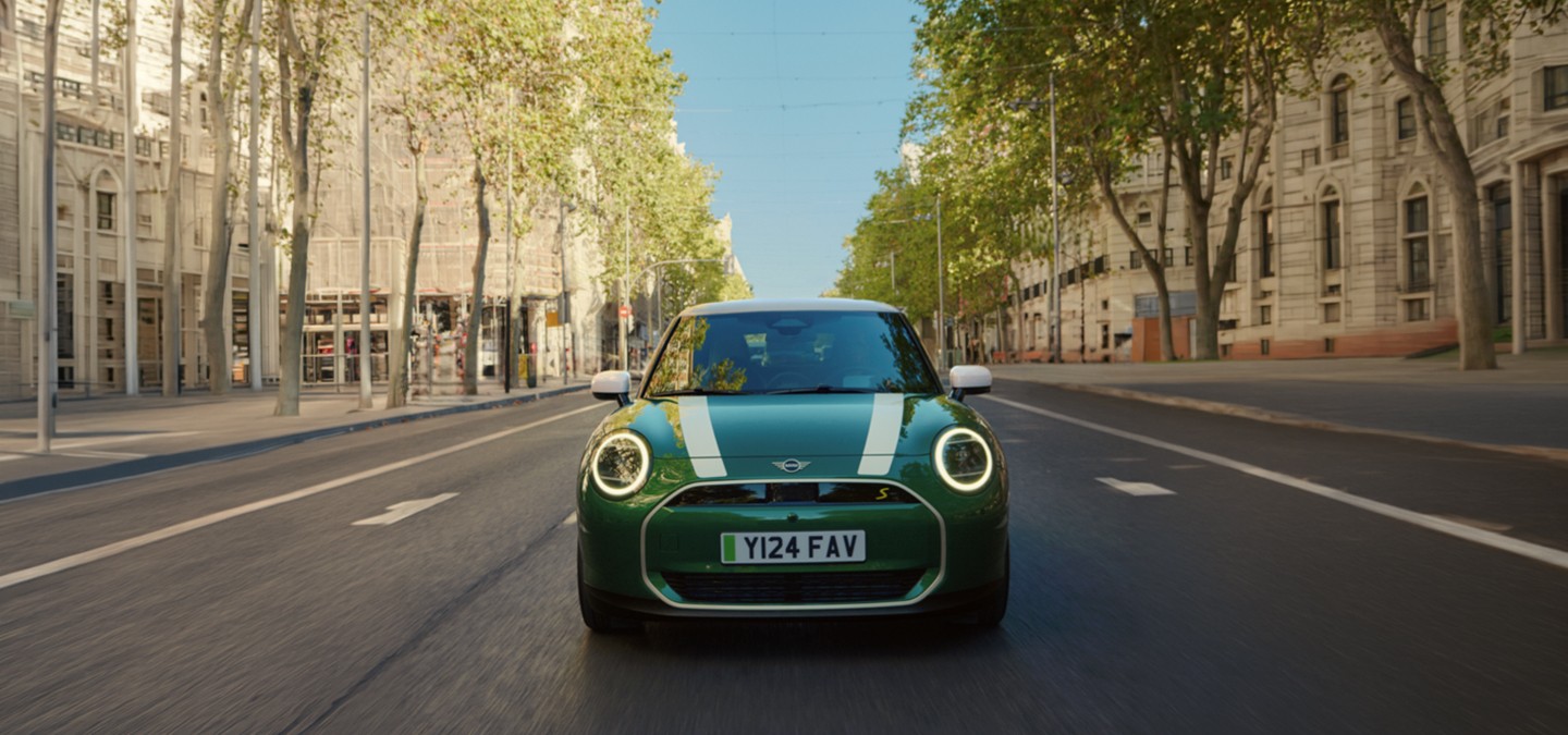 Front view of the MINI Cooper in Nanuq White with Black Roof parking.